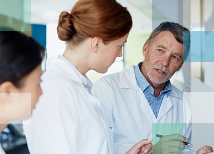 One male and one female eye care professionals discussing vision treatment plan with a female patient.